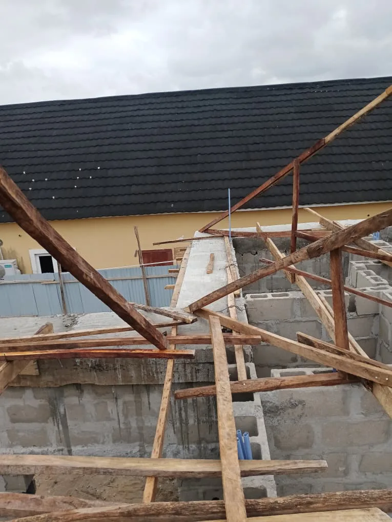 Early timber roof framing in progress. View 01.